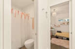 Step into a charming bedroom featuring a cozy bed with a vibrant yellow quilt and a plush pink rug.
