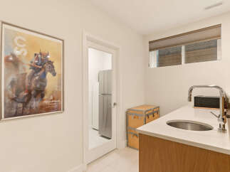 Discover a unique blend of art and functionality in this space, featuring a striking Calgary Stampede poster that adds a touch of vibrant culture.