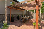Enjoy outdoor living under this stunning wooden pergola, perfect for al fresco dining and entertaining.