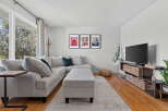 This living room boasts a comfortable sectional sofa with plush throw pillows, perfect for relaxing.