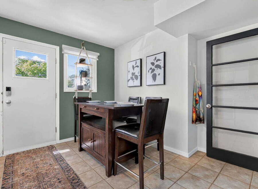 This charming dining area features a dark wood island with seating, perfect for casual meals or entertaining.