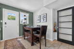 This charming dining area features a dark wood island with seating, perfect for casual meals or entertaining.