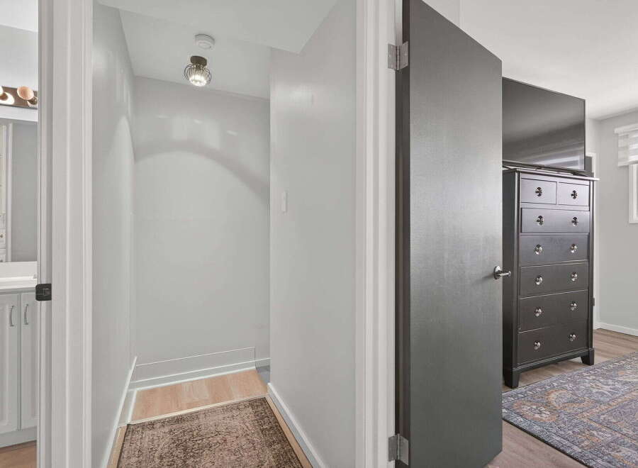 Step into this inviting hallway, featuring a stylish ceiling light and a smoke detector for added safety.