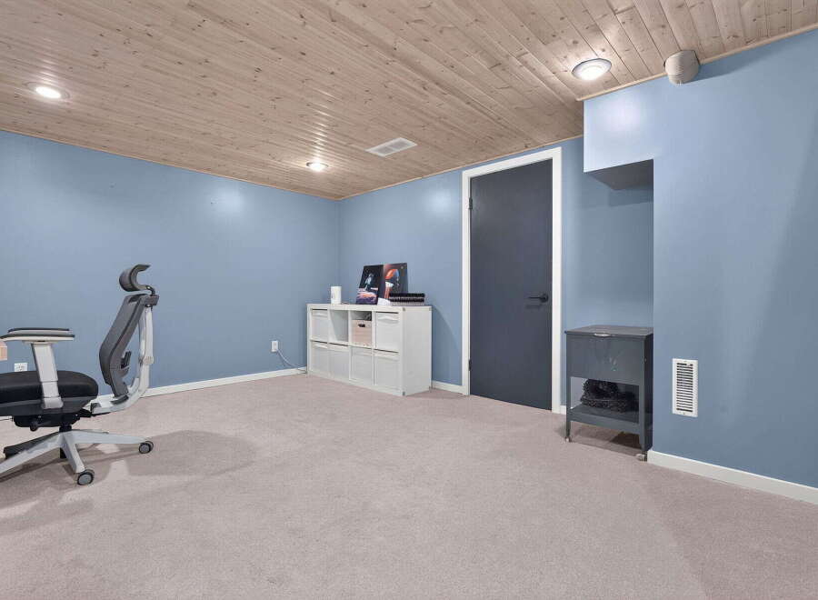 Discover this inviting space featuring a comfortable office chair and a sleek white storage unit, perfect for organization.