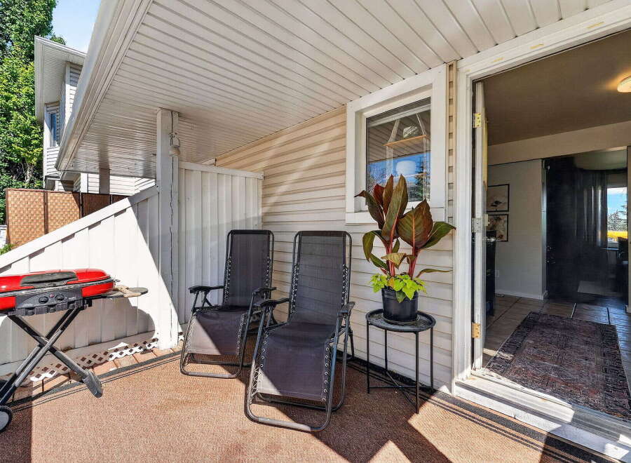 Enjoy outdoor living on this charming patio, perfect for summer barbecues with its included grill.
