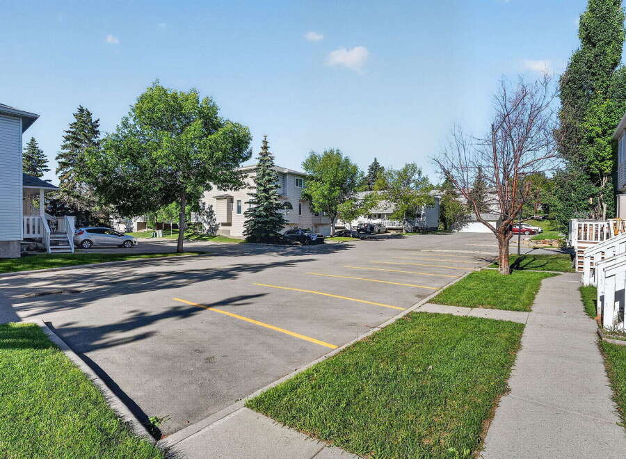 Discover this charming property featuring a well-maintained parking lot with ample space for residents and guests.