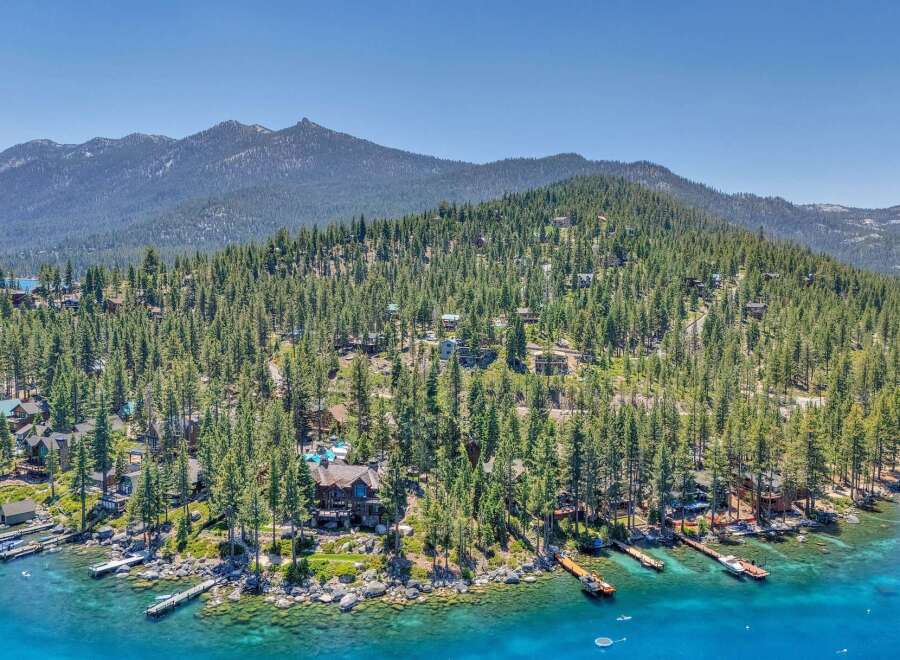 Experience luxury lakeside living with this stunning property featuring a private dock and breathtaking mountain views.
