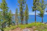 Experience breathtaking lake views from this stunning property, nestled amidst mature pine trees.