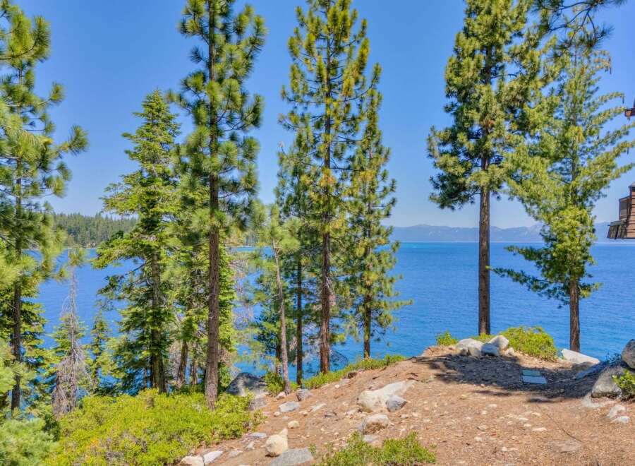 Experience breathtaking lake views from this stunning property, nestled amongst mature pine trees.