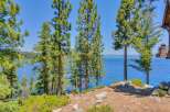 Experience breathtaking lake views from this stunning property, nestled amongst mature pine trees.