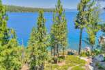 Experience breathtaking lake views from this stunning property, nestled amidst towering pine trees.