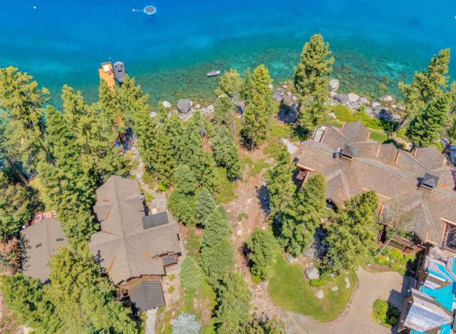 Experience luxury lakeside living with this stunning aerial view of a sprawling estate.