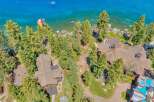 Experience luxury lakeside living with this stunning aerial view of a sprawling estate.