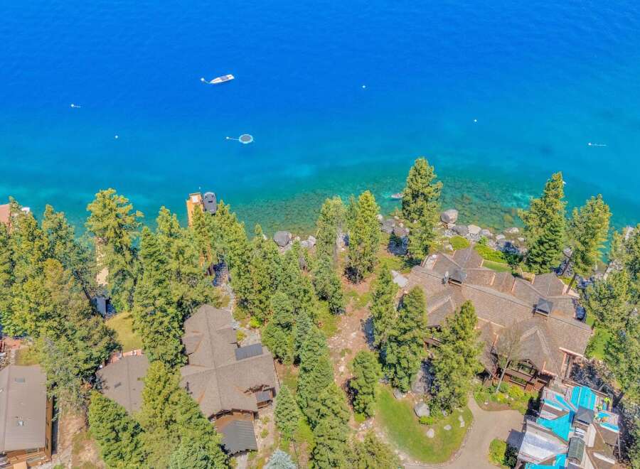 Experience luxury living with this stunning aerial view of a lakeside estate.