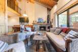 Experience cozy living in this inviting living room, featuring a magnificent stone fireplace as the centerpiece.