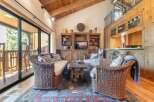 Experience rustic charm in this inviting living room, featuring a cozy wicker sofa and armchair perfect for relaxation.