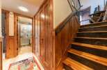 Step into a rustic charm with this inviting hallway featuring warm wood paneling and a cozy rug.
