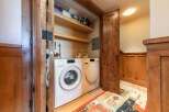 Discover the convenience of a dedicated laundry space featuring a stacked Miele washer and dryer.