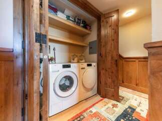 Discover the convenience of a dedicated laundry space featuring a stacked Miele washer and dryer.
