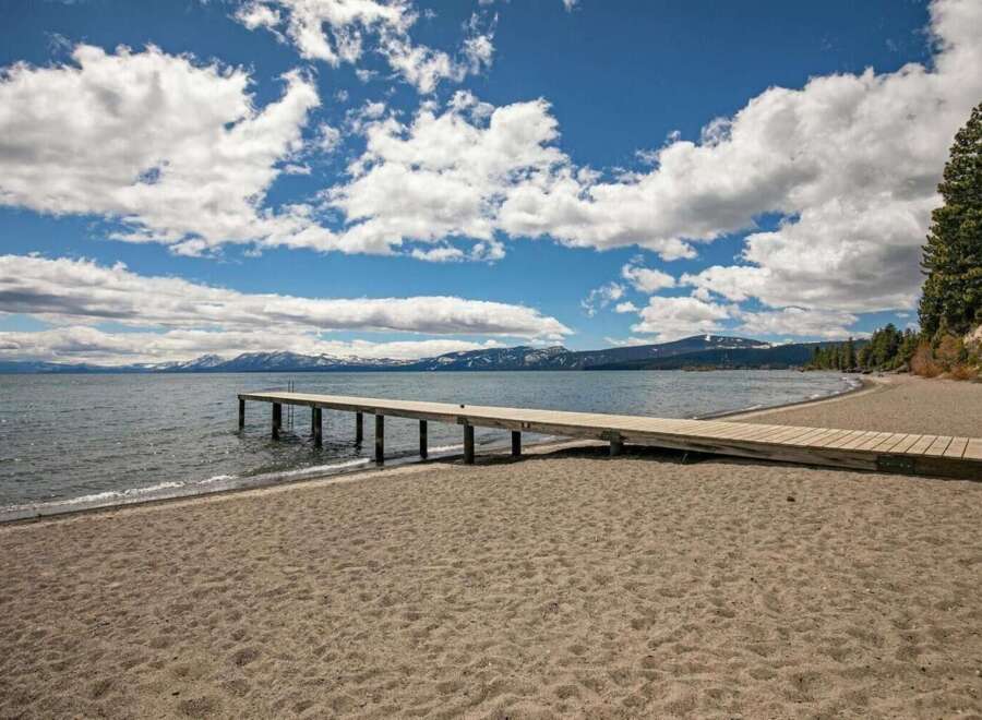 Enjoy direct access to the water with this stunning property featuring a private wooden pier extending into the serene lake.