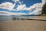 Enjoy direct access to the water with this stunning property featuring a private wooden pier extending into the serene lake.