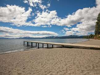 Enjoy direct access to the water with this stunning property featuring a private wooden pier extending into the serene lake.