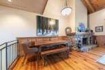 Experience rustic charm in this inviting dining area, featuring a sturdy wooden table and bench set perfect for family gatherings.