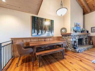 Experience rustic charm in this inviting dining area, featuring a sturdy wooden table and bench set perfect for family gatherings.