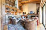 Experience rustic charm in this inviting living space, featuring a grand stone fireplace as the centerpiece.