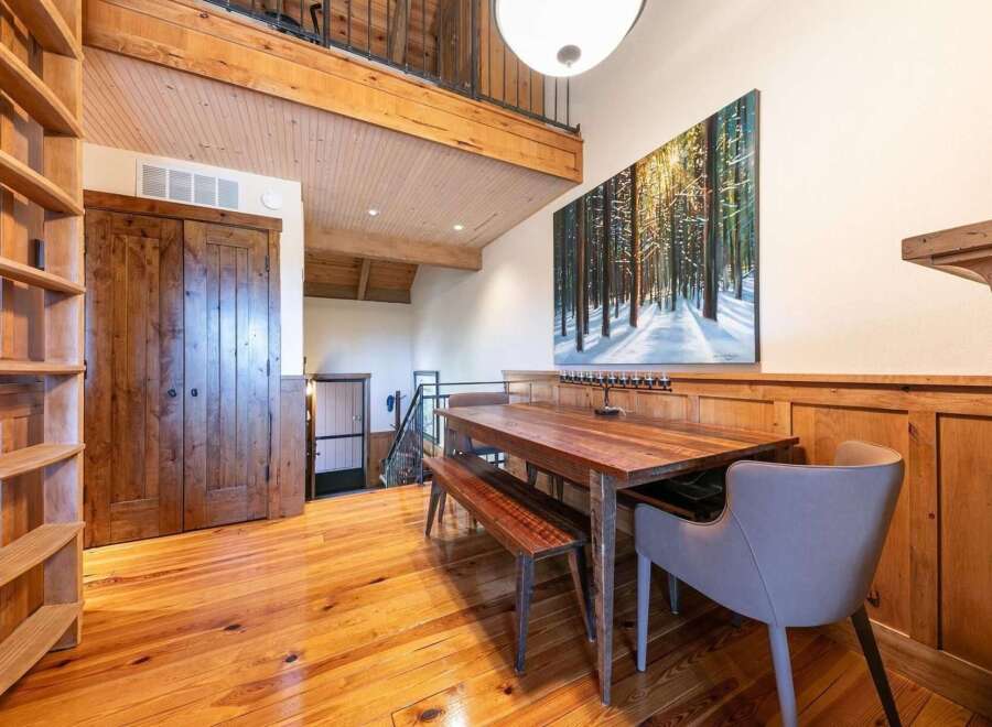 Experience rustic charm and modern comfort in this inviting dining area, featuring a beautiful wooden dining table and bench set perfect for family meals.