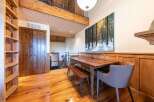 Experience rustic charm and modern comfort in this inviting dining area, featuring a beautiful wooden dining table and bench set perfect for family meals.