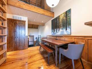 Experience rustic charm and modern comfort in this inviting dining area, featuring a beautiful wooden dining table and bench set perfect for family meals.