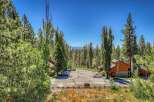 Nestled amidst towering pine trees and lush greenery, this property offers a serene mountain retreat.