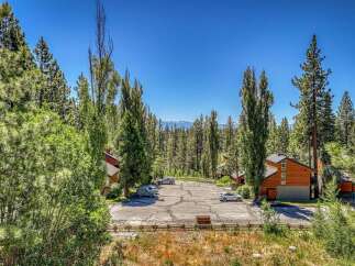 Nestled amidst towering pine trees and lush greenery, this property offers a serene mountain retreat.