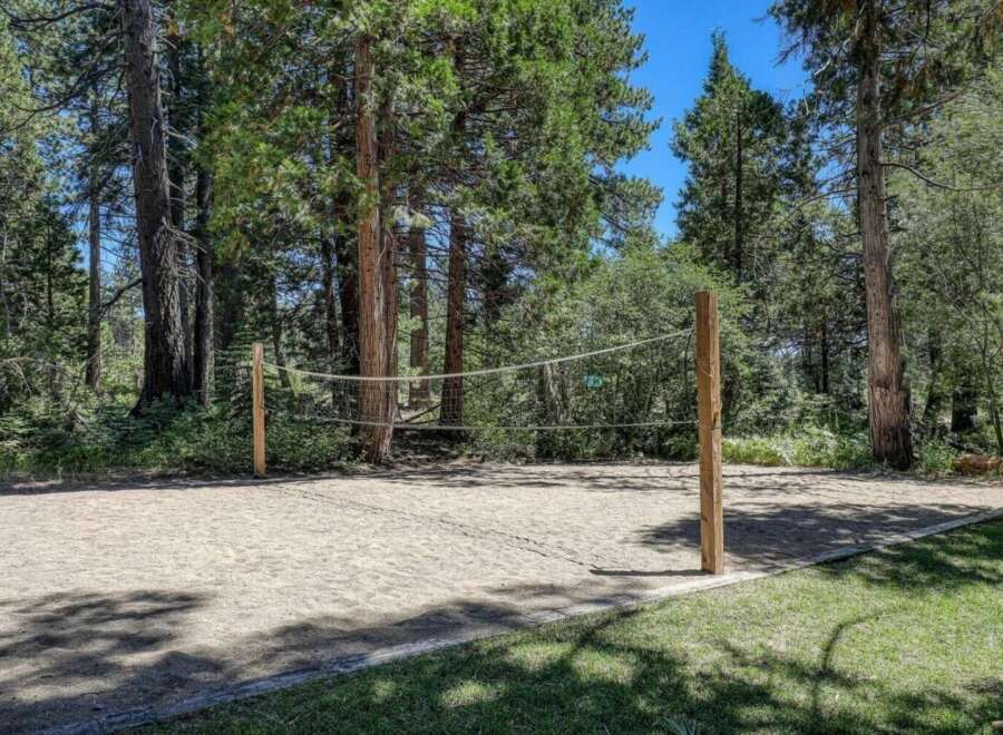 Enjoy outdoor recreation with this private sand volleyball court, perfect for friendly games and summer fun.
