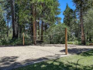 Enjoy outdoor recreation with this private sand volleyball court, perfect for friendly games and summer fun.