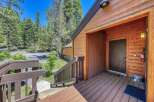 Experience the charm of this mountain retreat, featuring a welcoming wooden deck leading to the entrance.