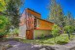 Discover modern living in this stunning multi-level home, featuring a striking cedar exterior and a concrete base.