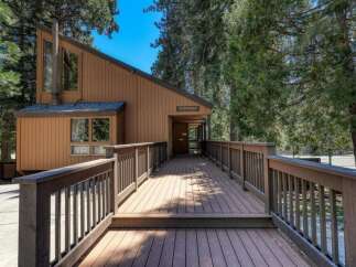 Discover this charming clubhouse, nestled amongst tall trees and accessed by a welcoming wooden deck.