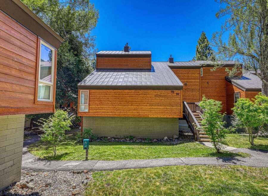 Experience modern mountain living in this beautifully crafted wood-sided home featuring a sleek metal roof and large windows that invite natural light.