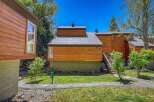 Experience modern mountain living in this beautifully crafted wood-sided home featuring a sleek metal roof and large windows that invite natural light.