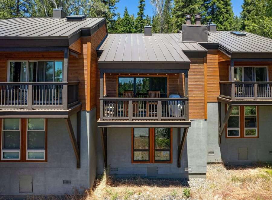 Experience modern mountain living in this stunning property featuring a sleek metal roof and warm wood siding.