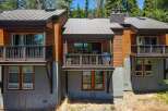 Experience modern mountain living in this stunning property featuring a sleek metal roof and warm wood siding.