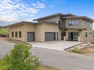 Experience modern luxury in this stunning contemporary home, featuring a striking stone and stucco exterior.