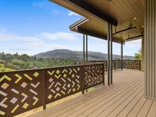 Experience breathtaking mountain views from this stunning modern home's expansive deck.