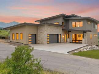 Experience modern luxury in this stunning contemporary home, nestled against a backdrop of majestic mountains.
