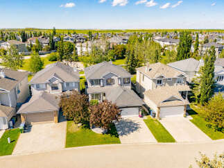 Discover this charming suburban neighborhood featuring a collection of well-maintained family homes with spacious yards and attached garages.