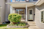 Charming home featuring a welcoming covered porch with white columns, perfect for enjoying your morning coffee.