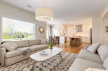 Experience open-concept living in this beautifully appointed home, featuring a spacious living area seamlessly flowing into a modern kitchen.