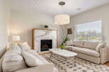 Experience modern living in this beautifully appointed living room, featuring a striking marble fireplace as the centerpiece.